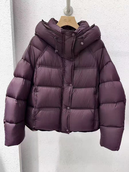 Purple puffer jacket with hood on hanger, trendy winter fashion at FashionRay