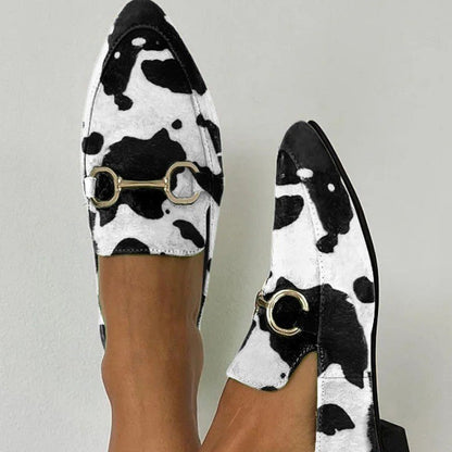 Black and white cow print loafers with gold buckle detail from FashionRay