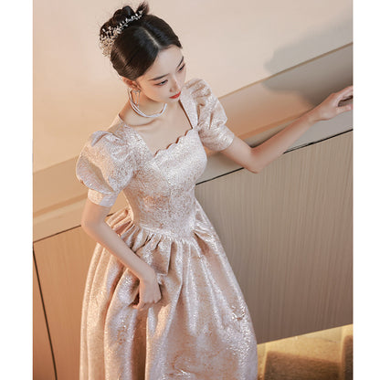 Elegant woman in a shimmery puff sleeve ball gown with tiara, FashionRay trendy formal dress