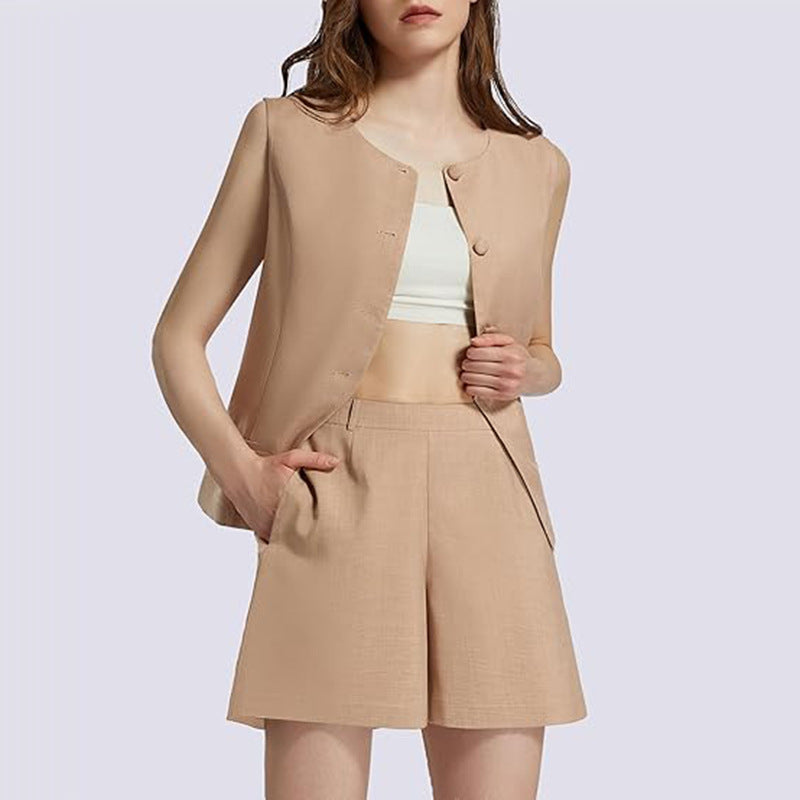 Woman models neutral beige shorts suit and white crop top from FashionRay, light background