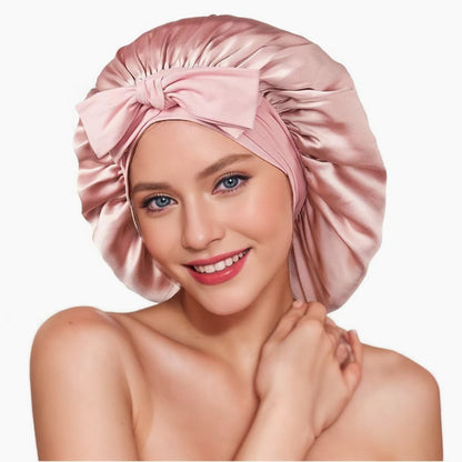 Woman wearing a pink satin bonnet with bow, smiling, FashionRay trendy comfortable style