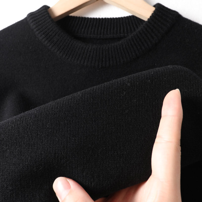 Close-up of soft black knit sweater on hanger, showcasing FashionRay’s comfortable fabric
