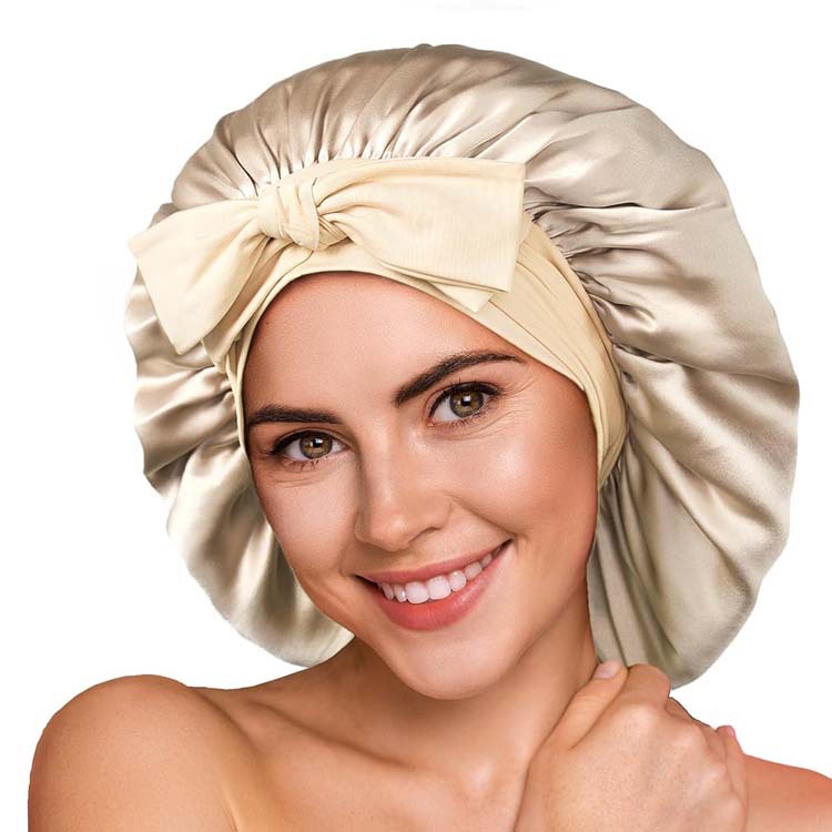 Woman wearing a shiny satin sleep bonnet with bow, FashionRay stylish comfort accessory