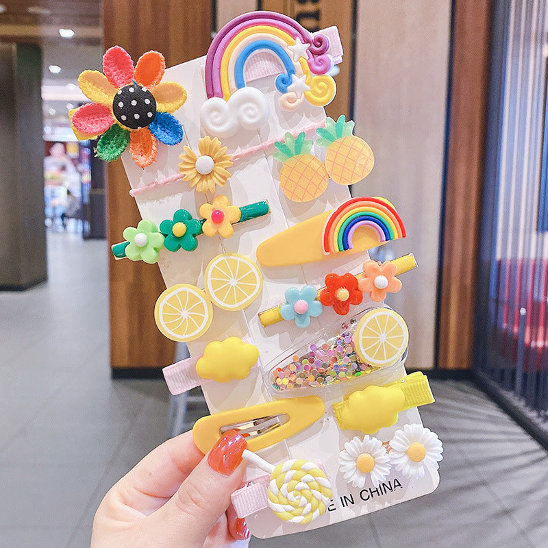 Bright, colorful FashionRay hair clips with fruit, rainbow, and flower designs on display card.
