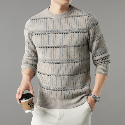Man in striped beige knit sweater and white pants holding coffee, modern casual fashion